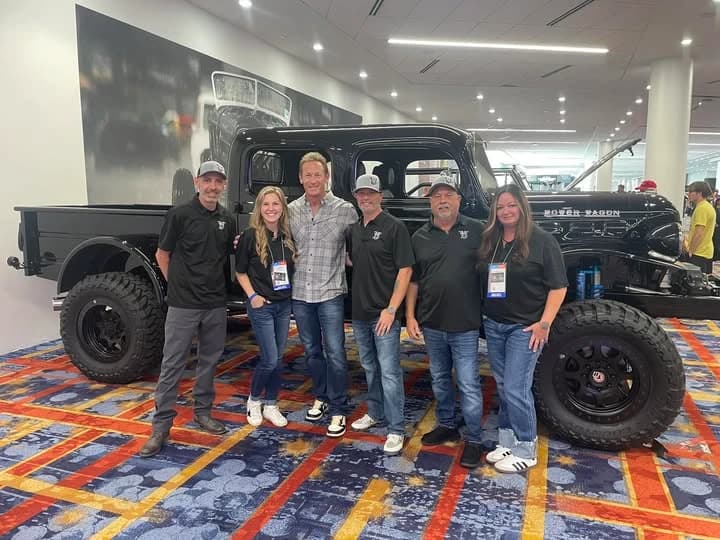 Members of the Vintage Dream Machines team beside the black four-door Power Wagon at SEMA 2025