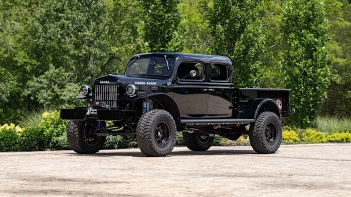 SYNISTA, the black 1946 four-door Dodge Power Wagon, viewed from the front corner