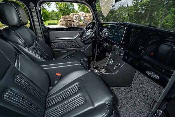 SYNISTA cabin with black leather seats, center console, and dashboard touchscreen — photo 6 of 23