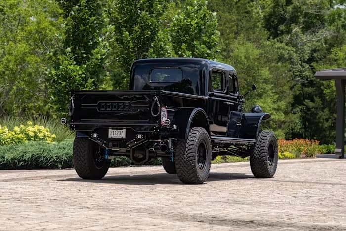 Rear three-quarter view of SYNISTA showing the Dodge tailgate and rear suspension — photo 5 of 23