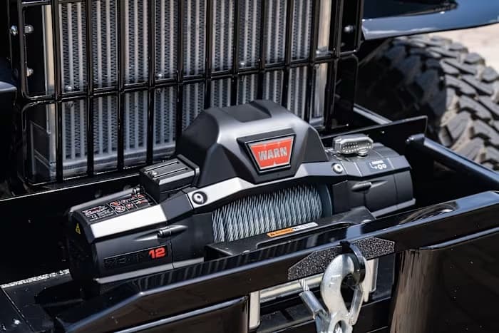 WARN winch mounted ahead of SYNISTA’s vertical-bar front grille — photo 17 of 23
