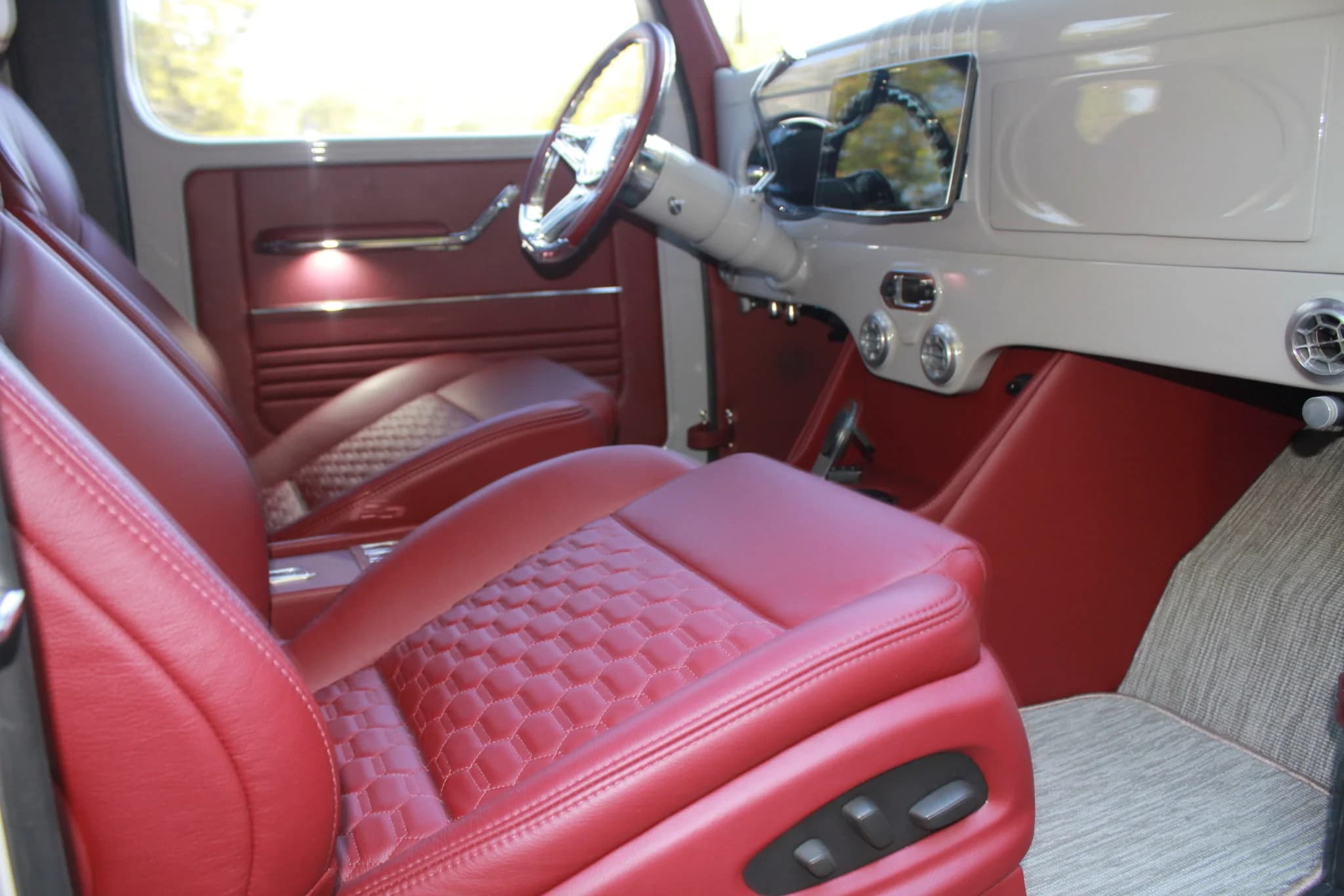 Chalk Power Wagon’s red front seat, polished steering wheel, and dashboard