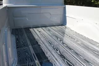 View toward the front of the pickup bed showing the wood grain and metal strips — photo 37 of 40