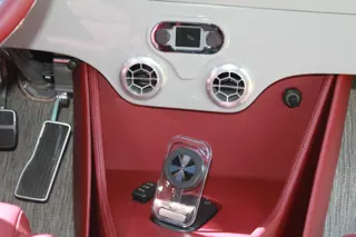 Center console with a floor shifter, round vents, and red trim — photo 11 of 40