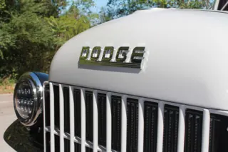 Chrome Dodge hood lettering above the grille and round headlight — photo 30 of 40