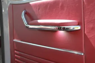 Red door upholstery with a polished handle and horizontal trim — photo 18 of 40