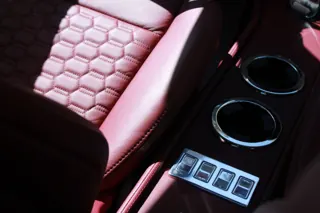 Red center console with cupholders and a row of switches — photo 14 of 40