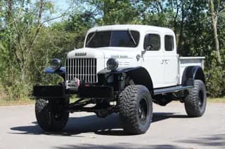 Closer front view showing the grille, four-door cab, and off-road stance — photo 2 of 40