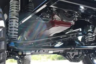 Close-up of the front suspension, axle, and steering components — photo 25 of 40