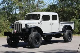 Front three-quarter view of the chalk-colored 1946 four-door Dodge Power Wagon with black fenders — photo 1 of 40