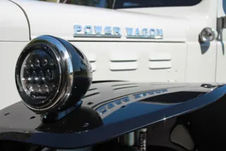 Round headlight beside the Power Wagon hood badge and black front fender — photo 31 of 40