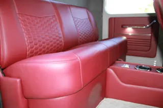 Red rear bench with patterned seat inserts and a center console — photo 15 of 40