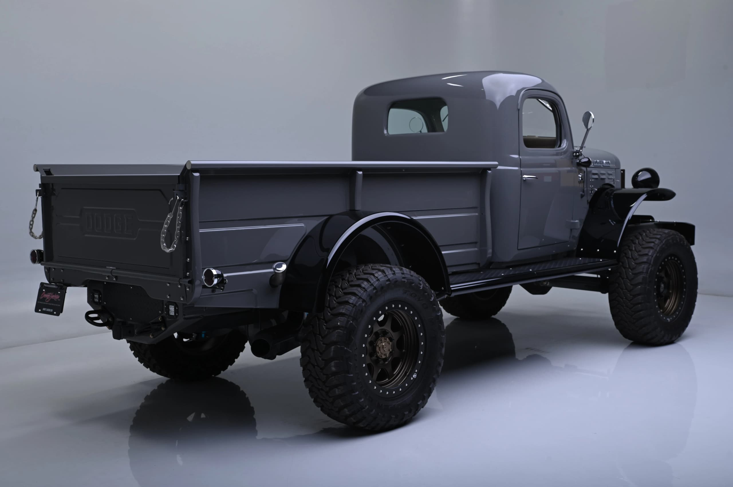 Rear three-quarter studio view of the gray Power Wagon and pickup bed — photo 3 of 8