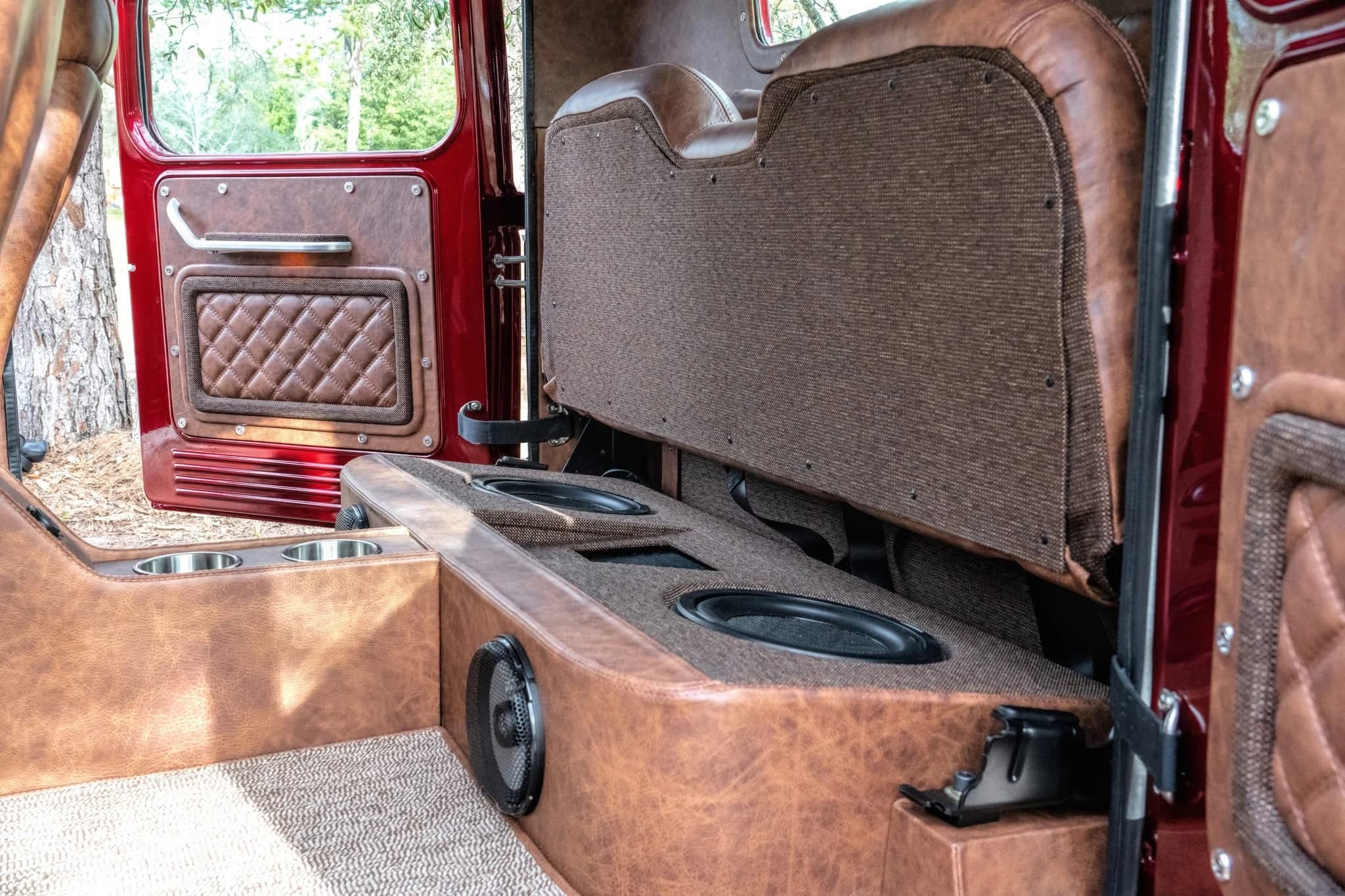 Rear seating area of the red Power Wagon with a folded seat and cupholders — photo 6 of 6
